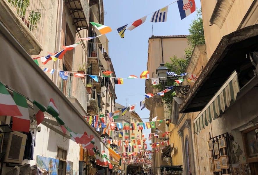 Narrow Sorrento streets with various little country flags overhead 