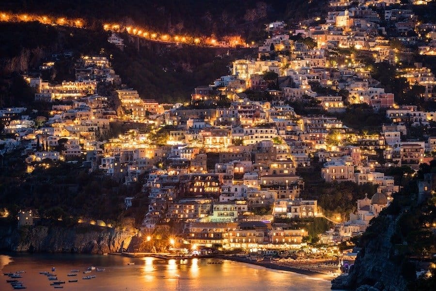 View of Positano at night with all the lights in the houses turned on 