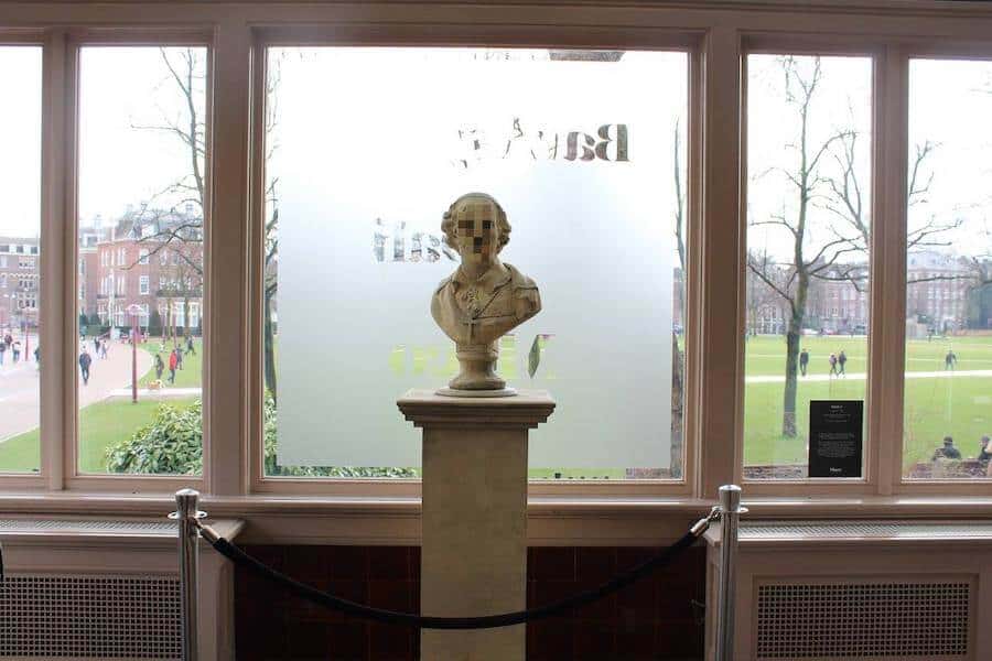 Statue in front of a window in MOCO museum 