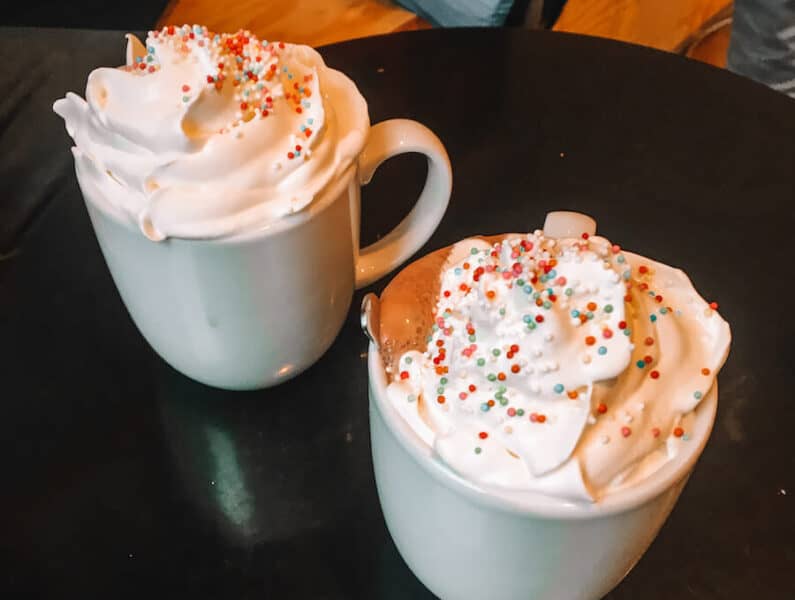 Two hot chocolates with whipped cream and sprinkles 