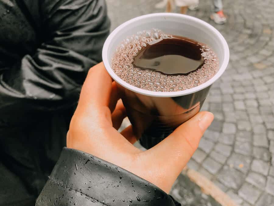 Hand holding a cup of warm red wine