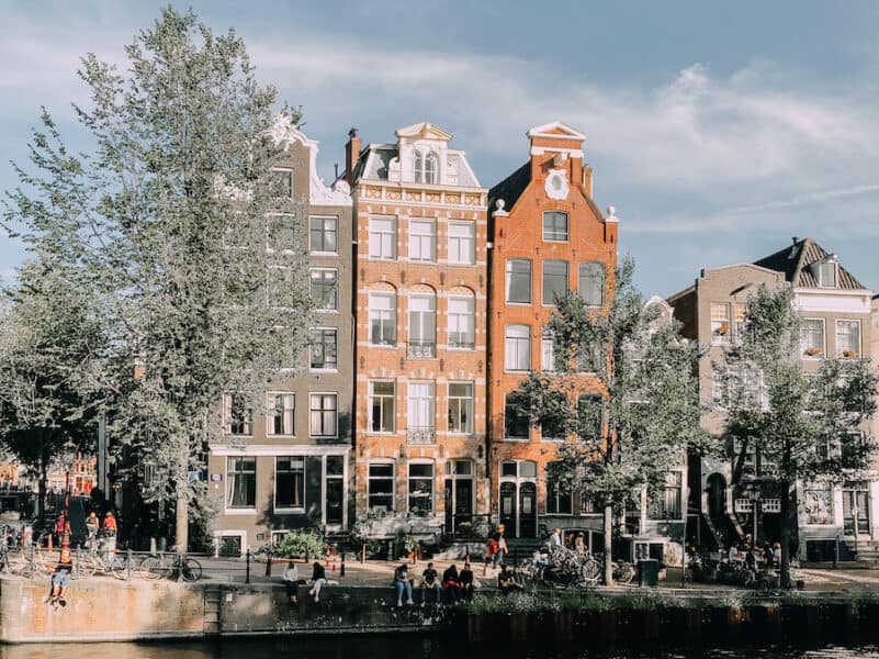 Orange hued houses in Amsterdam along a canal