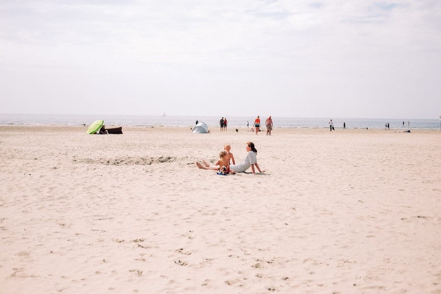 Mother and sons sitting on the IJmudien beach