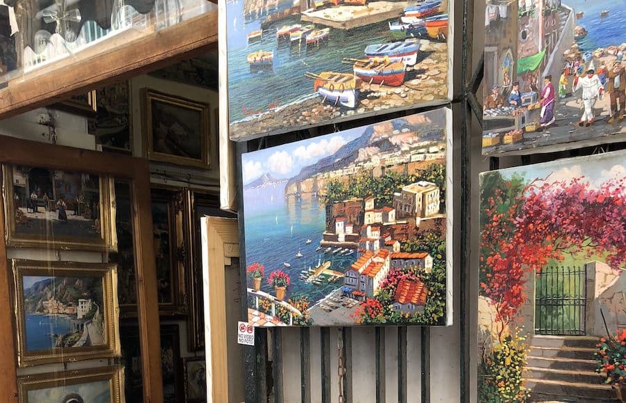 Paintings of Sorrrento hung in a shop