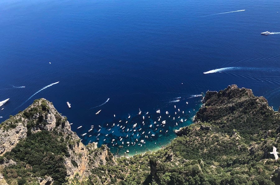 View of the mountains and boats in the water in Capri from above