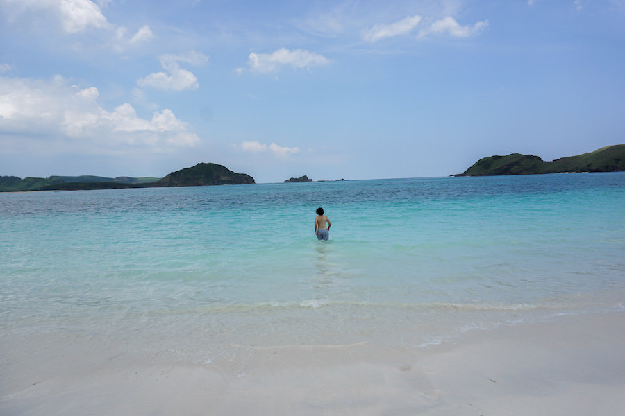 Man standing in the blue waters in Lombok