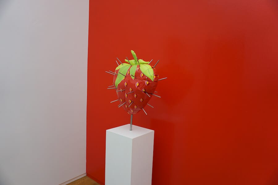 Cement strawberry that looks like a balloon at a museum in Amsterdam