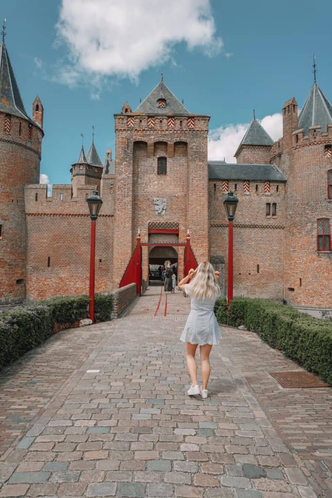 Girl walking into the gates of a castle