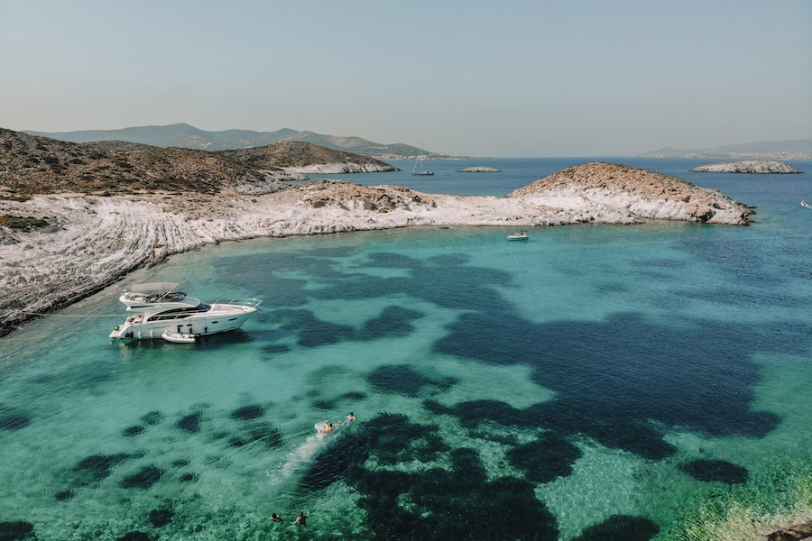 Blue water with a yacht on it