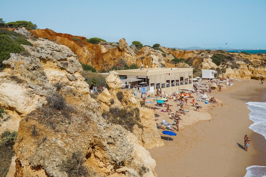 Beach surrounded by orange coloured rocks