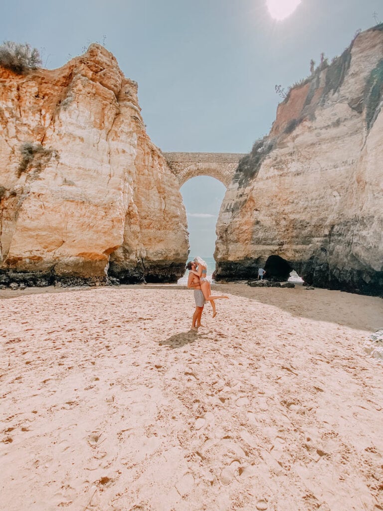 Two people kissing on the beach in the Algarve