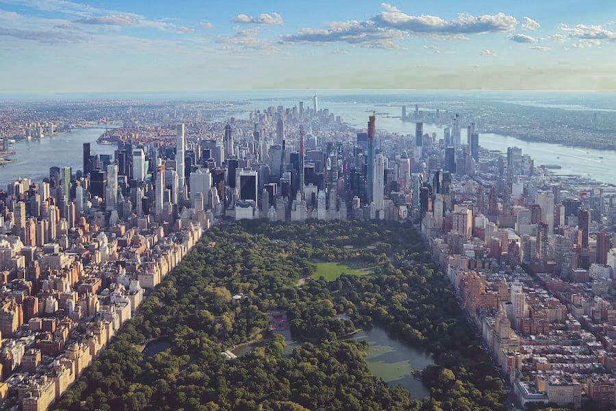 Ariel view of the green space of Central park surrounded by skyscrapers