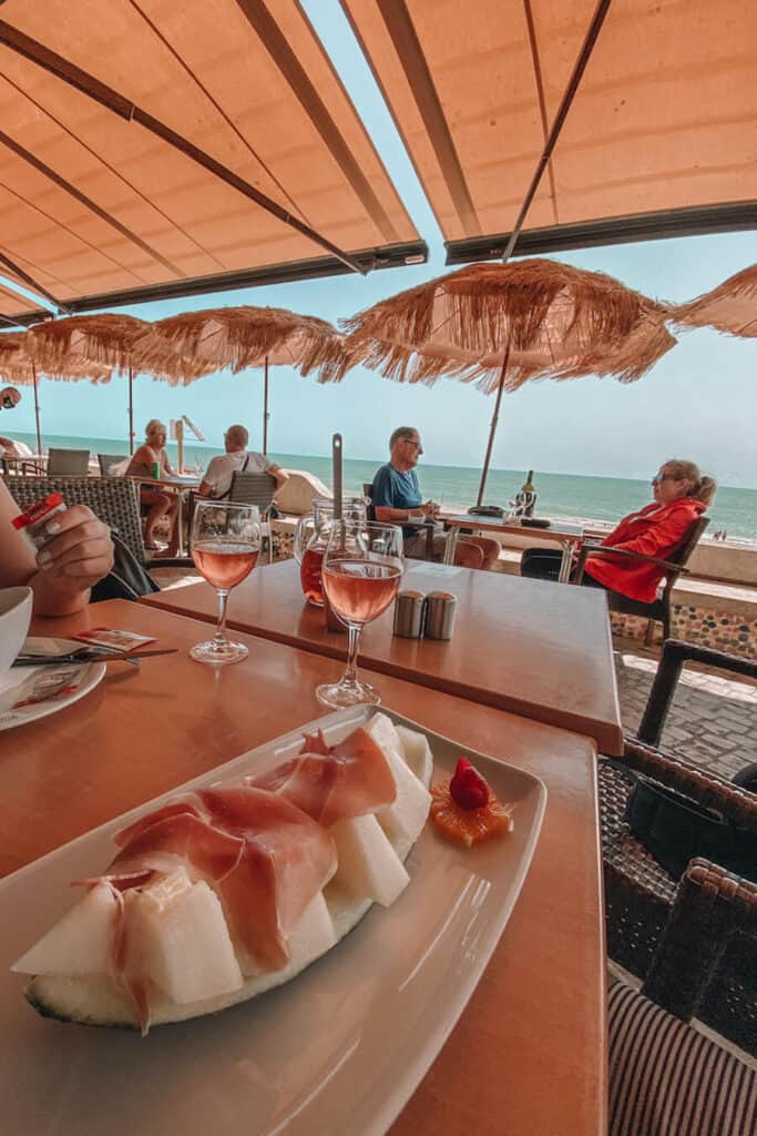 Food and wine with the beach in the distance