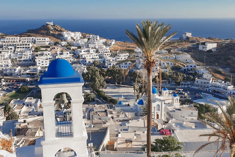 White buildings on and island surrounded by blue water