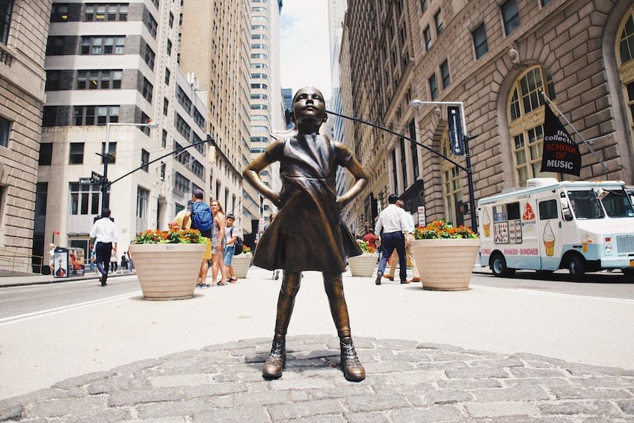 Statue of a little girl standing proud on Wall Street