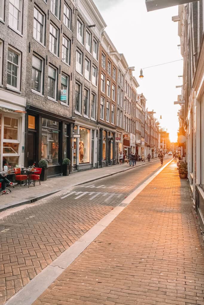 Street with sunset in the distance and houses