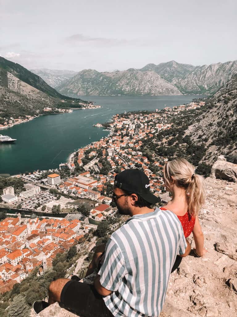 Couple sitting on the Kotor Fortress in Kotor, Montenegro
