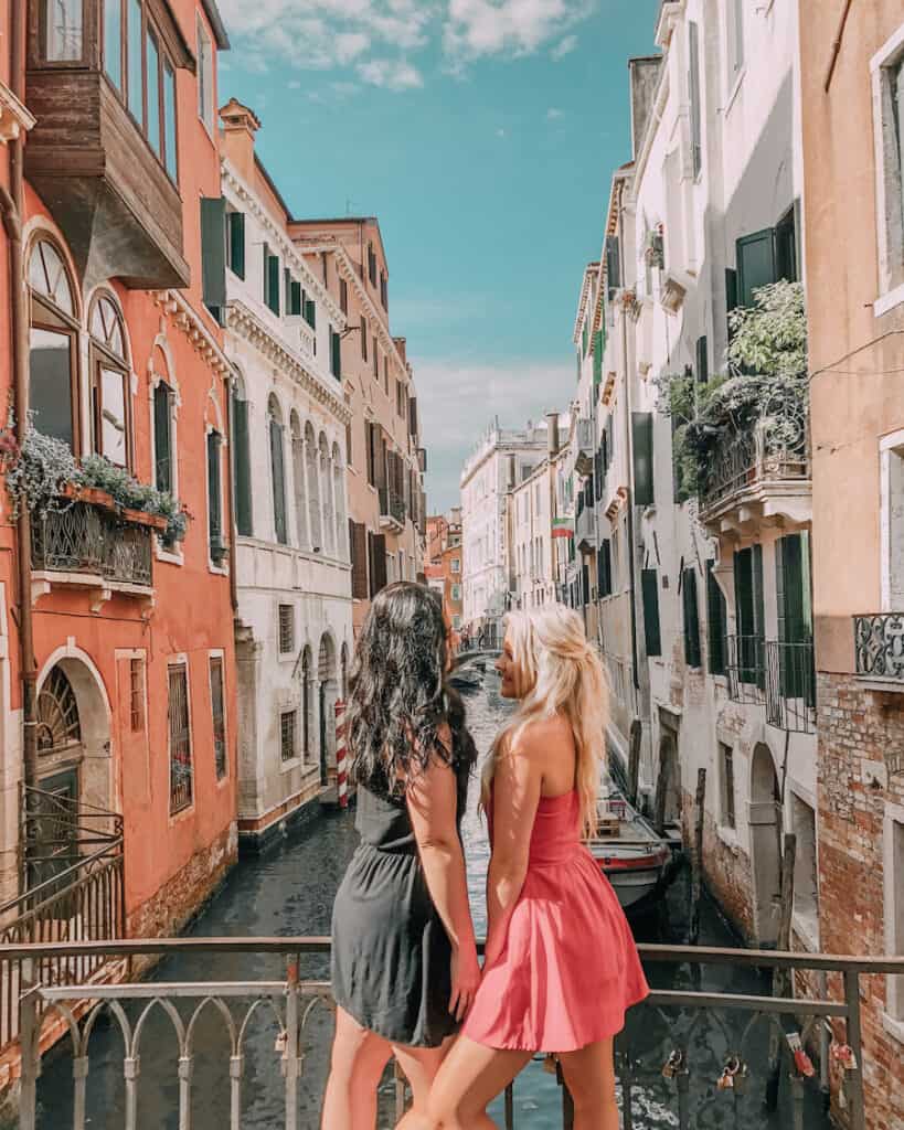 two girls standing on a bridge in Venice