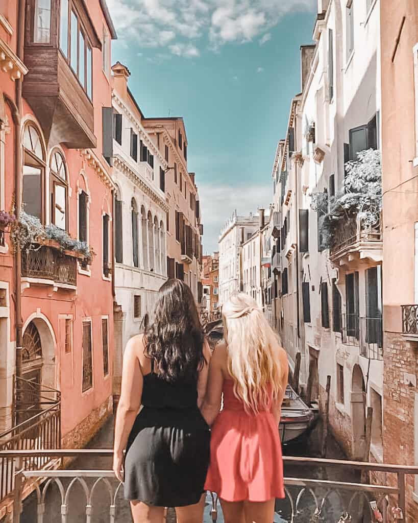 two girls standing on a bridge in Venice