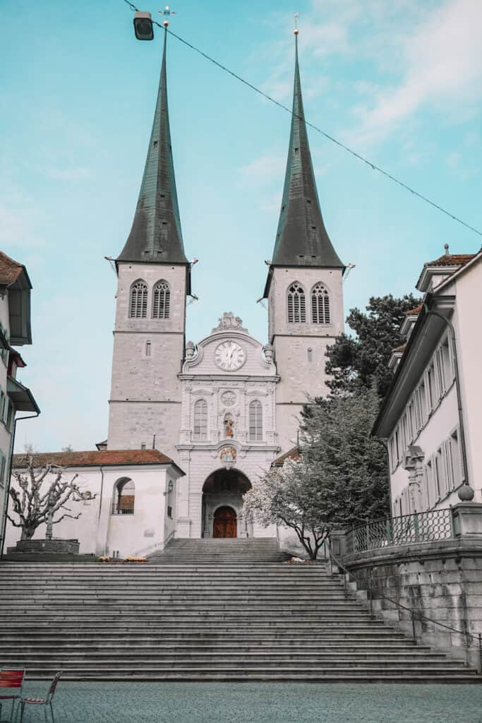 White stone church with green spires