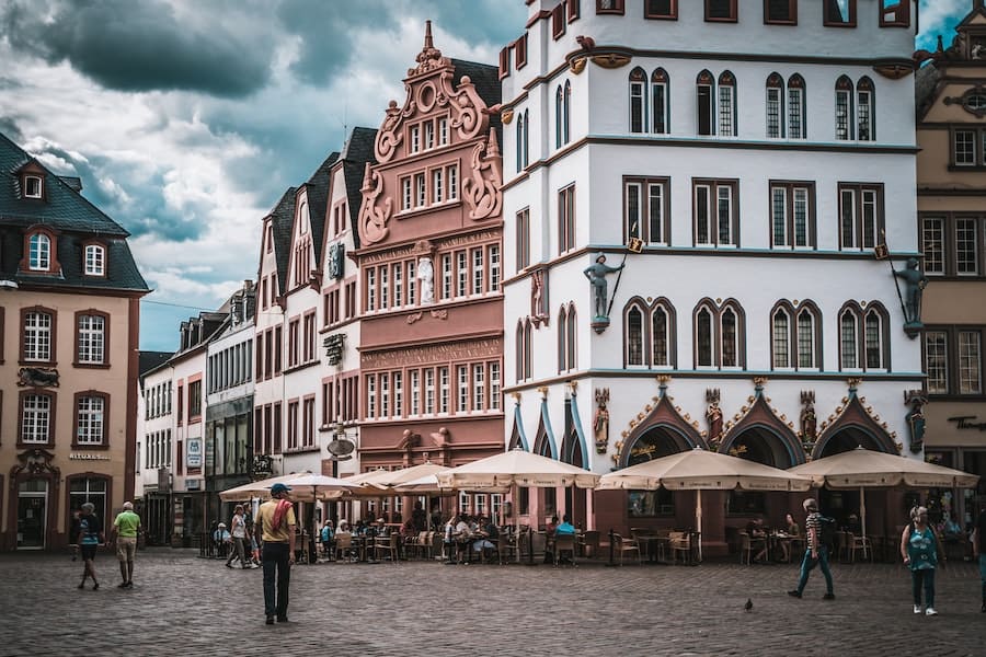 White and pink buildings in a cobblestone square