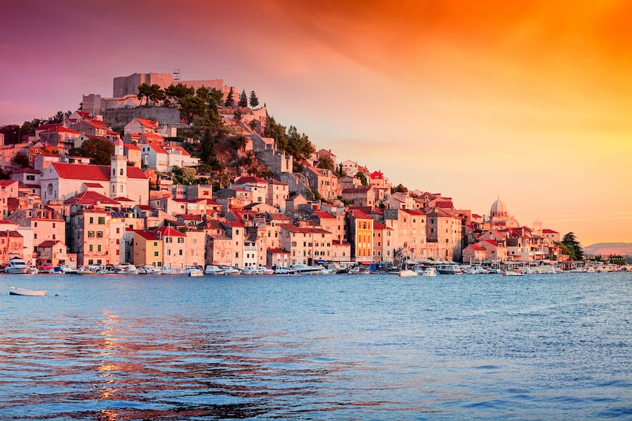 Sunset in old town of Sibenik, Croatia. Waterfront view with reflection