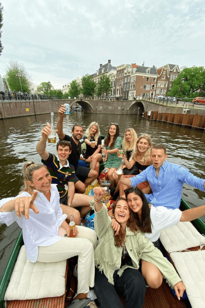 A group of people enjoying some drinks on a boat in Amsterdam