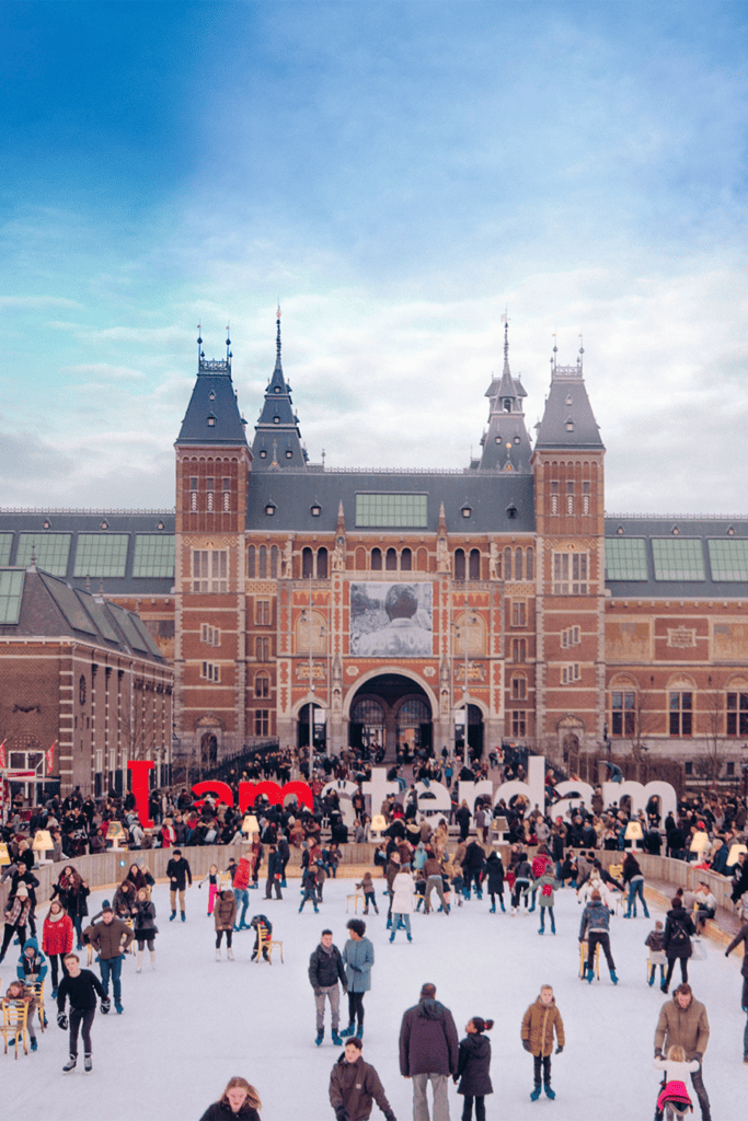 People ice-skating on a skating rink infront of the Rijksmuseum in Amsterdam.