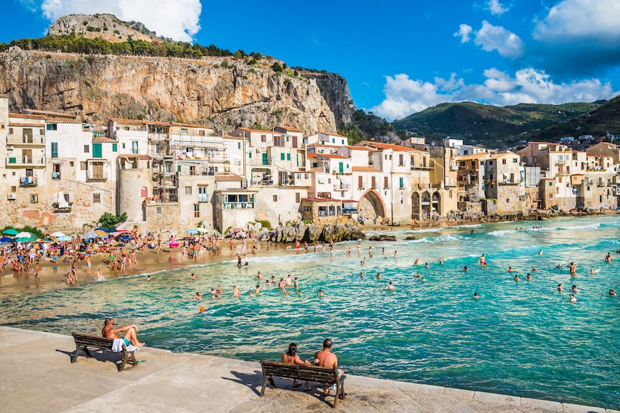 CEFALU, SICILY - AUGUST.12. 2017:People on beautiful beach at the bay in Cefalu, Sicily.Cefalu is very popular touristic old town in Sicily.
