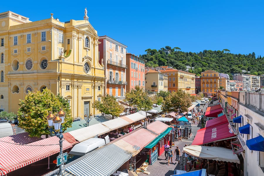 NICE, FRANCE - AUGUST 23, 2014: View of Cours Saleya - large pedestrian area famous for its flower, vegetable, spice and fish markets is one of the most popular places in Nice.
