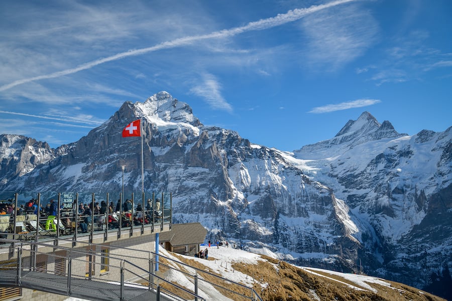 Grindelwald, Switzerland - February 22, 2020: Tourists having snacks with beautiful views in restaurant above Grindelwald,Switzerland during February 2020