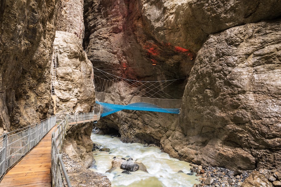 Glacier gorge with the river Weisse Lutschine and the climbing net Spiderweb in Grindelwald in the Bernese Oberland in Switzerland
