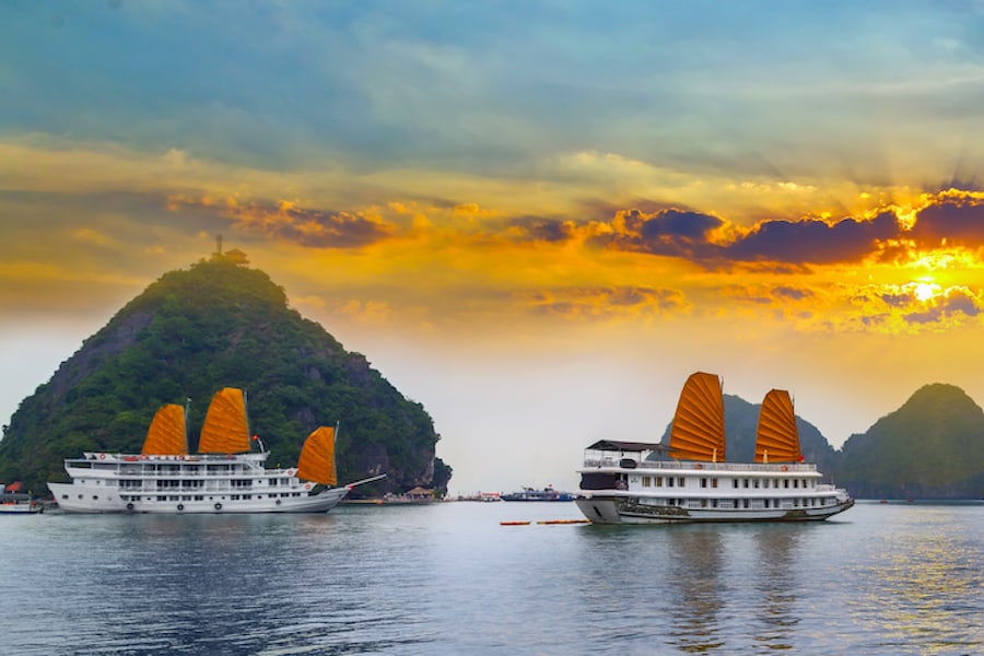 Sunset over Ha Long bay islands Halong mountains in South China Sea, Vietnam. UNESCO World Heritage Site Asia.