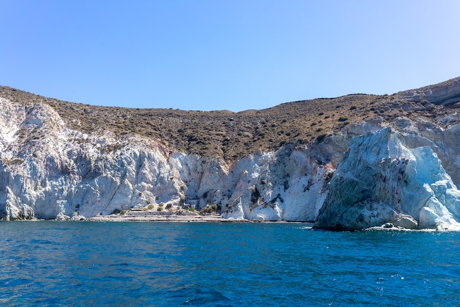 Panoramic view of white beach, Akrotiri, Santorini, Cyclades, Greece. Shot from sailing boat. blue sea and blue sky