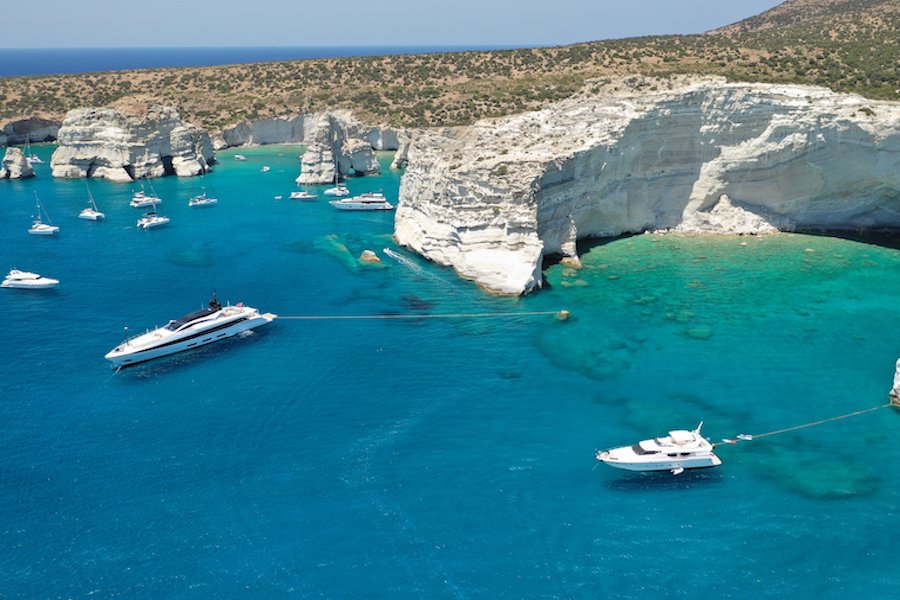 Aerial drone photo of Kleftiko a beautiful scenic white volcanic rock formation bay visited by sail boats and yachts with turquoise crystal clear sea and caves, Sea Meteora of Greece, Milos island