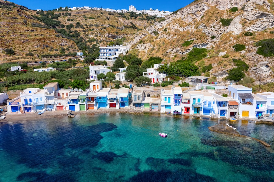 Aerial view to the beautiful syrmata fishing village Klima on the cylcadic island of Milos, Greece, with colorful boat houses and emerald sea