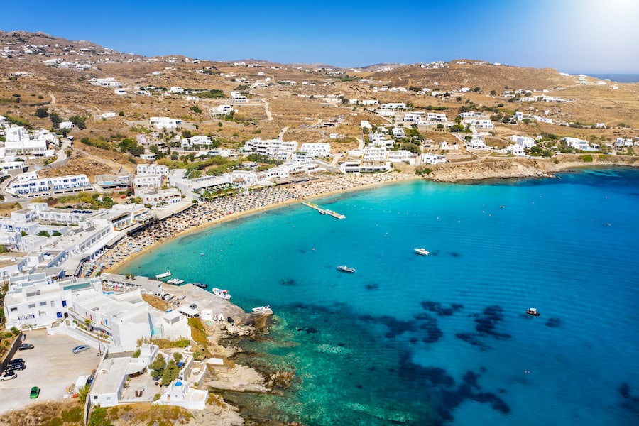 Panoramic aerial view of the popular Platis Gialos beach on the Greek island of Mykonos with turquoise sea