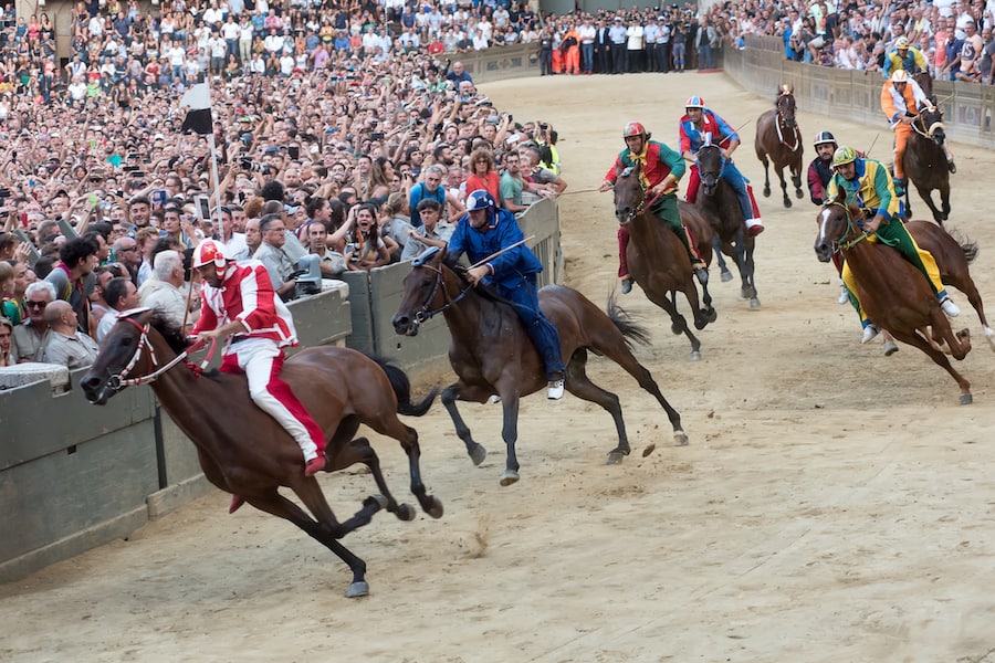 Riders compete in the famous horse race 'Palio di Siena', in the medieval square "Piazza del Campo", Siena, Italy. The Palio is held twice a year. This edition was won by the district "contrada della Lupa"