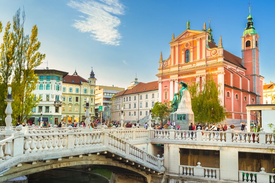 Romantic Ljubljana's city center: river Ljubljanica, Triple Bridge, Tromostovje, Preseren square and Franciscan Church of the Annunciation. Ljubljana, Slovenia, Europe.