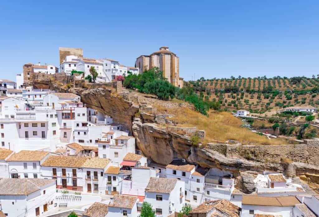 Setenil de las Bodegas, rustic village with cave houses on a sunny day with blue sky, in the province of Cadiz, Andalusia, Spain.