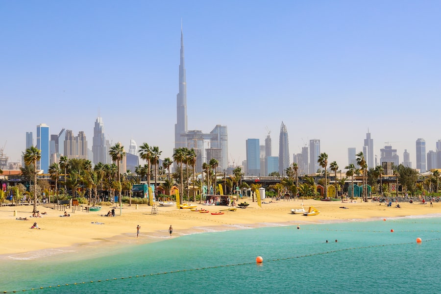 Dubai beach La Mer, people rest, in the distance the skyscrapers of the city. United Arab Emirates Dubai 