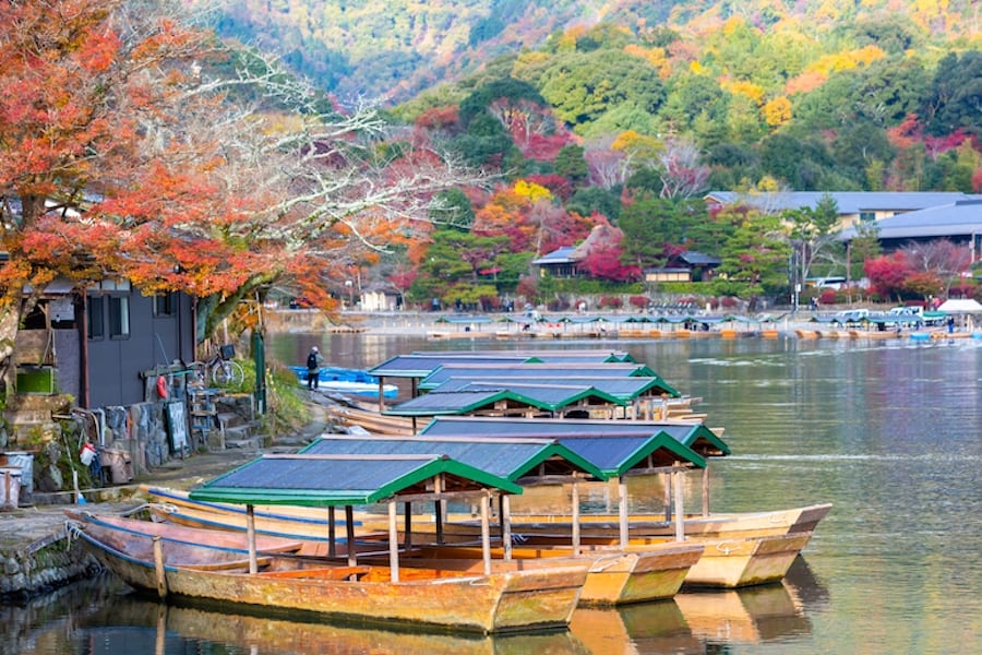 Boat ride pier at Hozugawa River, boat for tourists to enjoy the autumn view along the bank of Hozu river, Arashiyama, Kyoto, Japan.