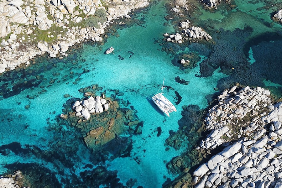 aerial view of boat on the blue crystal water of Lavezzi island in Corsica from France