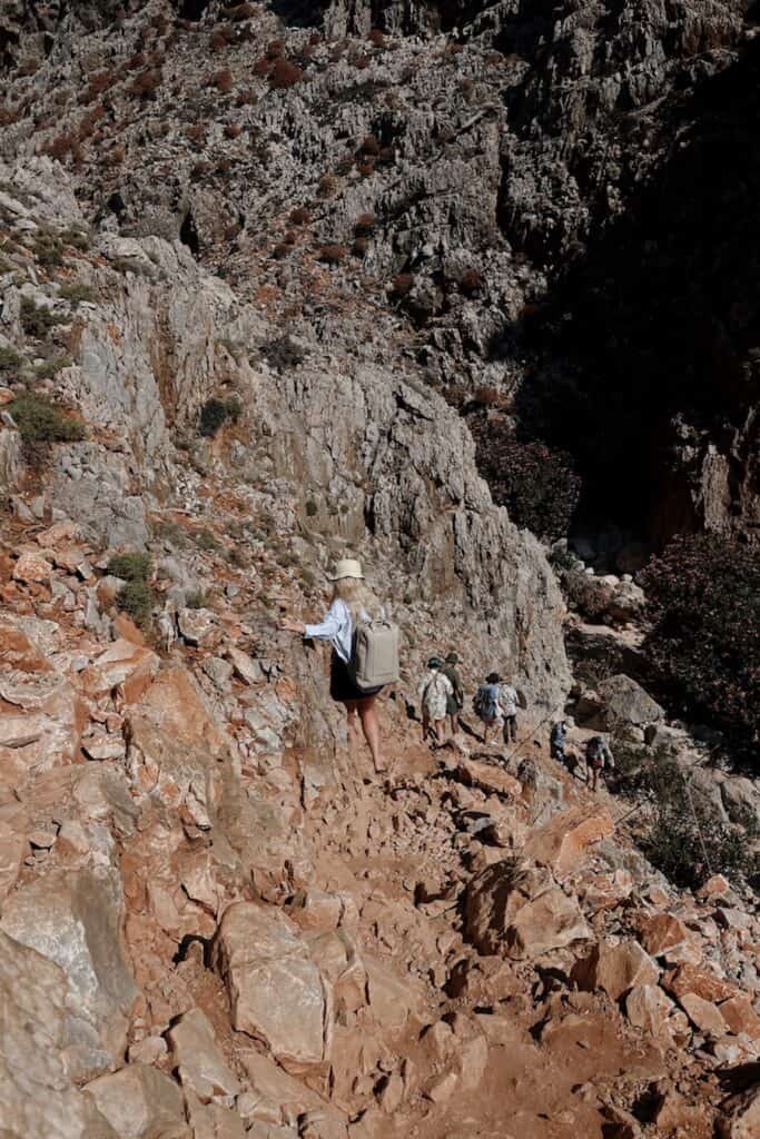 Hiking down a rocky cliff in Crete
