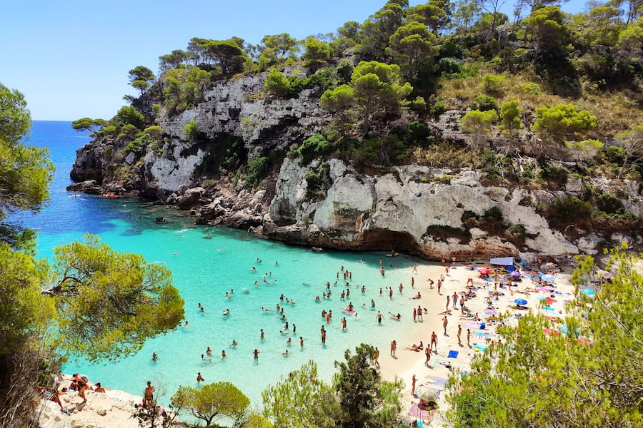 Cala Macarelleta famous paradise beach with turquoise water and pine forests on south coast of Menorca Island, Balearic Islands, Spain.