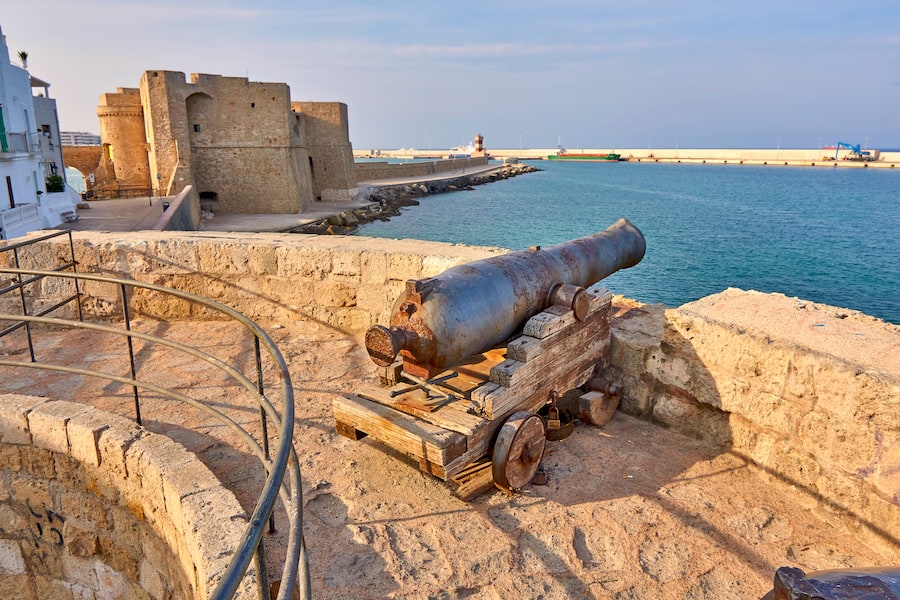 Medieval Defense Cannon and Turret In Front Of Castle Carlo V At Sunset in beautiful Monopoli - Apulia - Puglia - Italy