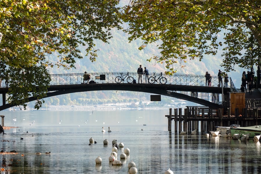 View of the Pont des Amours (Love Bridge) in the city of Annecy, in Haute-Savoie, France. In the background, there is the famous lake.