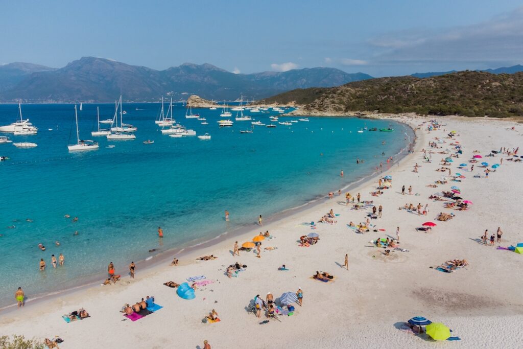 Aerial view of Loto Beach in the Agriates Desert northwest of Saint Florent near the Cap Corse, Corsica, France - White sand Lotu Beach with azure waters in the Mediterranean Sea
