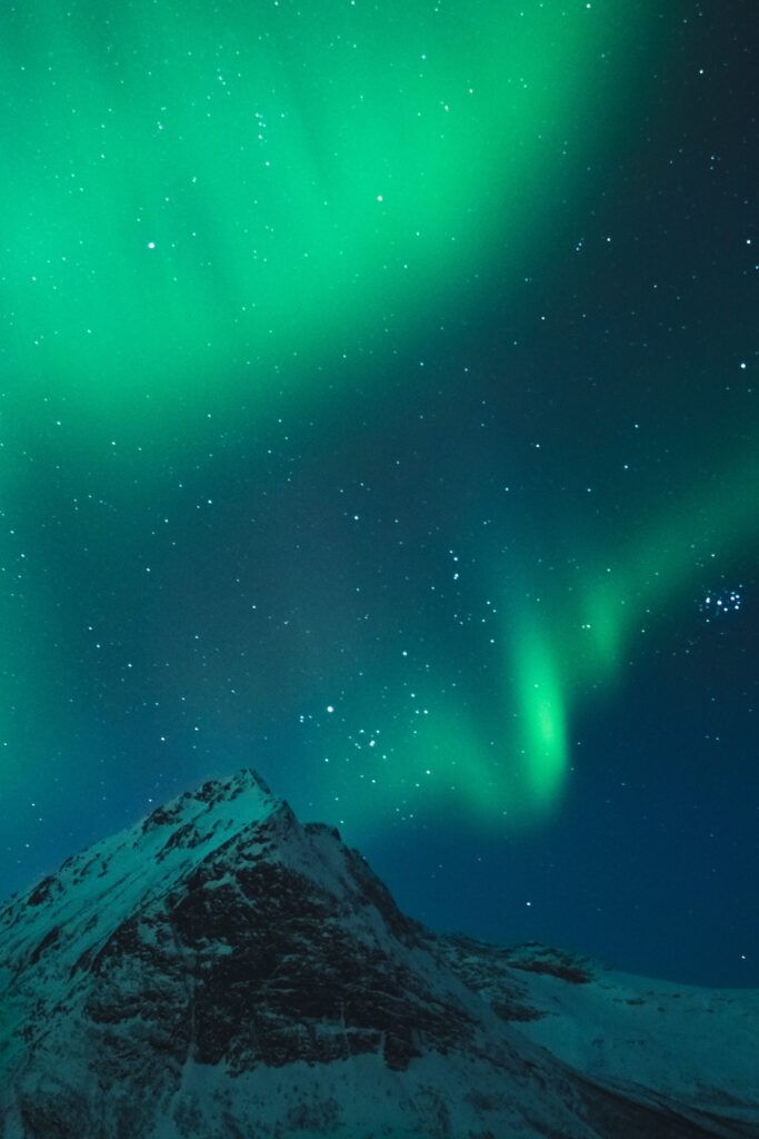 Powerful Northern Lights behind a beautiful mountain