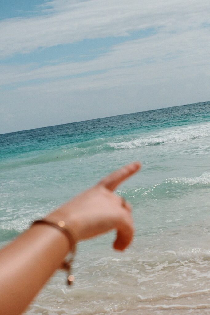 Girl pointing at the ocean in Tulum